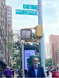 Mark Heutlinger next to the Harry T. Burleigh Place street sign