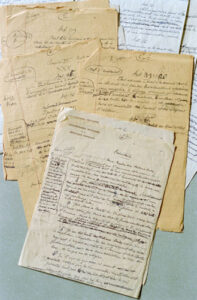 Photographs of paper drafts of the UDHR on a table 